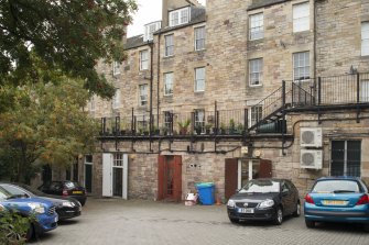View of flat-roofed 'mews' on rear elevation of 30-64 St Mary's Street, from Gullan's Close, Canongate, Edinburgh, from NE.