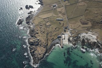 Oblique aerial view of Hynish, Tiree, looking SW.