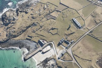 Oblique aerial view of Hynish, Tiree, looking S.