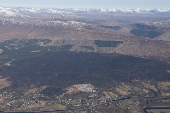 General oblique aerial view of Corpach, Fort William, with the moorland burning beyond, looking NW.