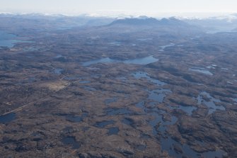 General oblique aerial view with Quinag and Loch Assynt in the distance, looking E.