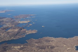 General oblique aerial view of Eddrachillis Bay centred on Eilean an Achaidh and the site of the Drumbeg wreck, looking SW.