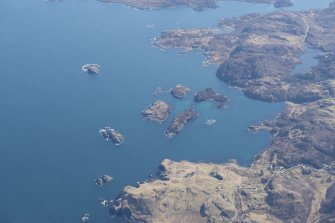 General oblique aerial view of Eddrachillis Bay centred on Eilean an Achaidh and the site of the Drumbeg wreck, looking E.