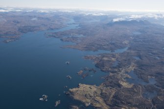 General oblique aerial view of Eddrachillis Bay centred on Eilean an Achaidh and the site of the Drumbeg wreck with Quinag beyond, looking E.