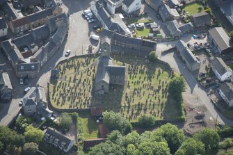 Oblique aerial view of St Serf's Church with the Glasgow University excavations on the edge of the churchyard, looking W.