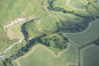Oblique aerial view of Kay Craig under excavation with Castle Craig beyond, looking SSE.