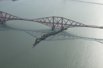 Oblique aerial view of part of the Forth Bridge centred on Inchgarvie, looking SW.