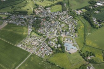 Oblique aerial view of Longside, the Old Parish Church, Parish Church and Longside School, looking NNE.