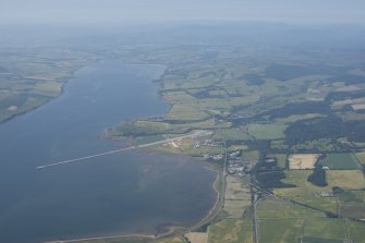 General oblique aerial view of Evanton Village, Evanton Airfield and quay, looking SSW.