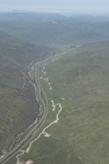 General oblique aerial view of the Pass of Drumochter showing the route of the Creiff to Dalnacardoch Military Road and the construction of the Beauly to Denny power line, looking N.