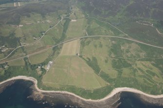 Oblique aerial view of Navidale Farm, Navidale House and St Ninian's Chapel, looking NW.