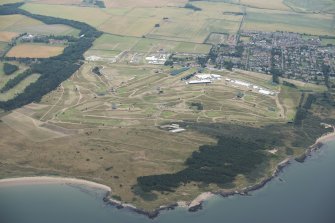 Oblique aerial view of Muirfield golf course showing the set up for the Open Championship 2013 with Gullane beyond, looking SSE.