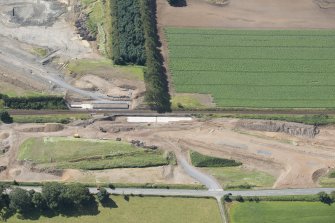 Oblique aerial view of the works along the A75 Dunragit Bypass to the SW of Dunragit village, looking SSE.