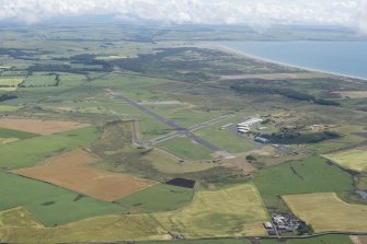 General oblique aerial view of West Freugh Airfield with Luce Sands beyond, looking ESE.