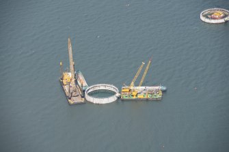Oblique aerial view of the bridge supports under construction, looking NE.