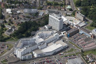 Oblique aerial view of Victoria Hospital, Kirkcaldy, looking ENE.