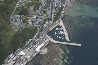 Oblique aerial view of Gardenstown and harbour, looking to the SSW.