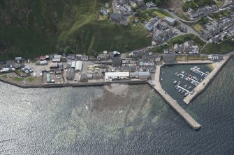 Oblique aerial view of Gardenstown and harbour, looking to the SSE.