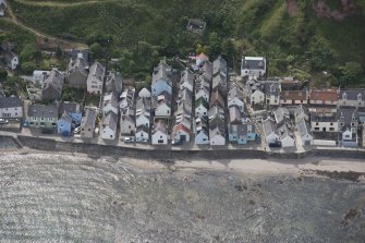 Oblique aerial view of Gardenstown and sea wall, looking to the SE.