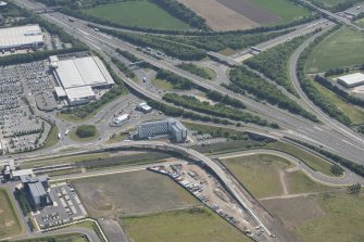 General oblique aerial view of Cultins Road centred on the tramworks, looking SE.