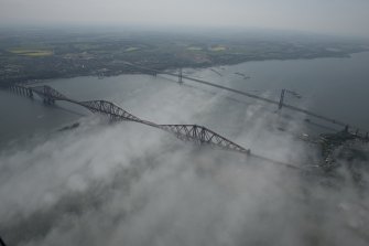 General oblique aerial view of the Forth Bridge and the road bridge, looking SW.