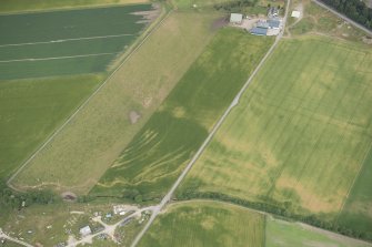 Oblique aerial view of the cropmarks of the rig and furrow, looking NE.