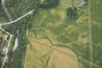 Oblique aerial view of the cropmarks of the pits at Arcan Mains, looking WSW.