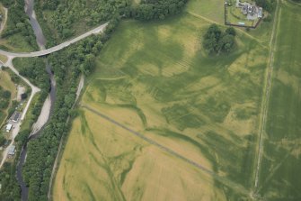 Oblique aerial view of the cropmarks of the pits at Arcan Mains, looking SW.