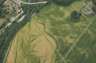 Oblique aerial view of the cropmarks of the pits at Arcan Mains, looking SW.