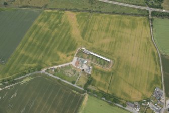 Oblique aerial view of the cropmarks of the enclosure and possible unenclosed settlement, looking NW.