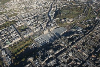 General oblique aerial view of the east end of Princes Street, including Waverley Station and the  Balmoral Hotel, looking to the NE.