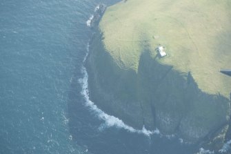 Oblique aerial view of Tobha Ronaigh, centred on North Rona lighthouse, looking to the SW.