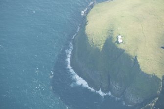 Oblique aerial view of Tobha Ronaigh, centred on North Rona lighthouse, looking to the SSW.