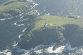 Oblique aerial view of the Flannan Isles, with the lighthouse on Eilean Mor in the foreground and Eilean Tighe beyond, looking to the SSW.
