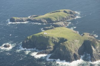 Oblique aerial view of the Flannan Isles, with the lighthouse on Eilean Mor in the foreground and Eilean Tighe beyond, looking to the S.