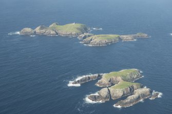 Oblique aerial view of Soraigh with Eilean Mor and Eilean Tighe, Flannan Isles, beyond, looking to the NNE.