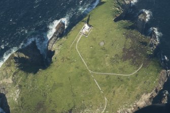 Oblique aerial view of the lighthouse and St Flannan's chapel on Eilean Mor, Flannan Isles, looking to the NE.