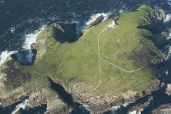 Oblique aerial view of the lighthouse and St Flannan's chapel on Eilean Mor, Flannan Isles, looking to the NNE.