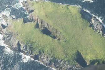 Oblique aerial view of the hut on Eilean Tighe, Flannan Isles, looking to the NW.