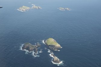 General oblique aerial view of Roaiream and Eilean a' Ghobha, Flannan Isles, with Eilean Mor and Soraigh beyond, looking to the ESE.