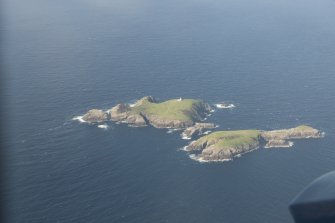 General oblique aerial view of Eilean Mor and Eilean Tighe, looking to the N.