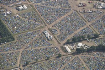 Oblique aerial view of the T in the Park festival at Balado, looking S.