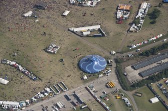 Oblique aerial view of the T in the Park festival at Balado, looking SE.