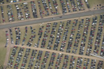 Oblique aerial view of the T in the Park festival at Balado, looking SE.