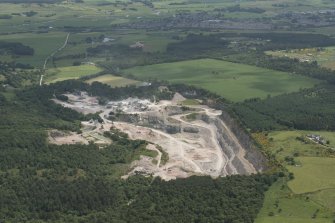 General oblique aerial view of Tom's Forest, Kemnay, grantite quarry, looking to the ESE.