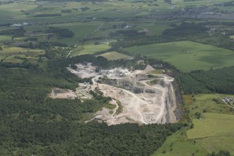 General oblique aerial view of Tom's Forest, Kemnay, grantite quarry, looking to the E.