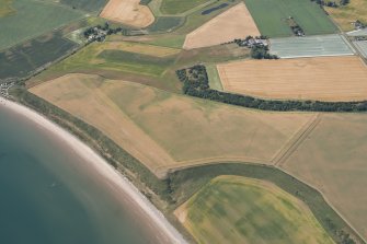 Oblique aerial view of the area of unenclosed settlement at Newbarns, Lunan Bay, looking SW.