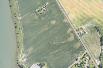 Oblique aerial view centred on the cropmark of the enclosure at Baldovie, looking ESE.