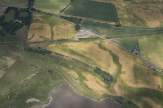 Oblique aerial view of cropmarks of the Roman camp, linear features, enclosures, settlement and rig, looking NNW.