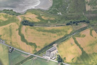 Oblique aerial view centred on the cropmarks at Gilrivie, looking S.